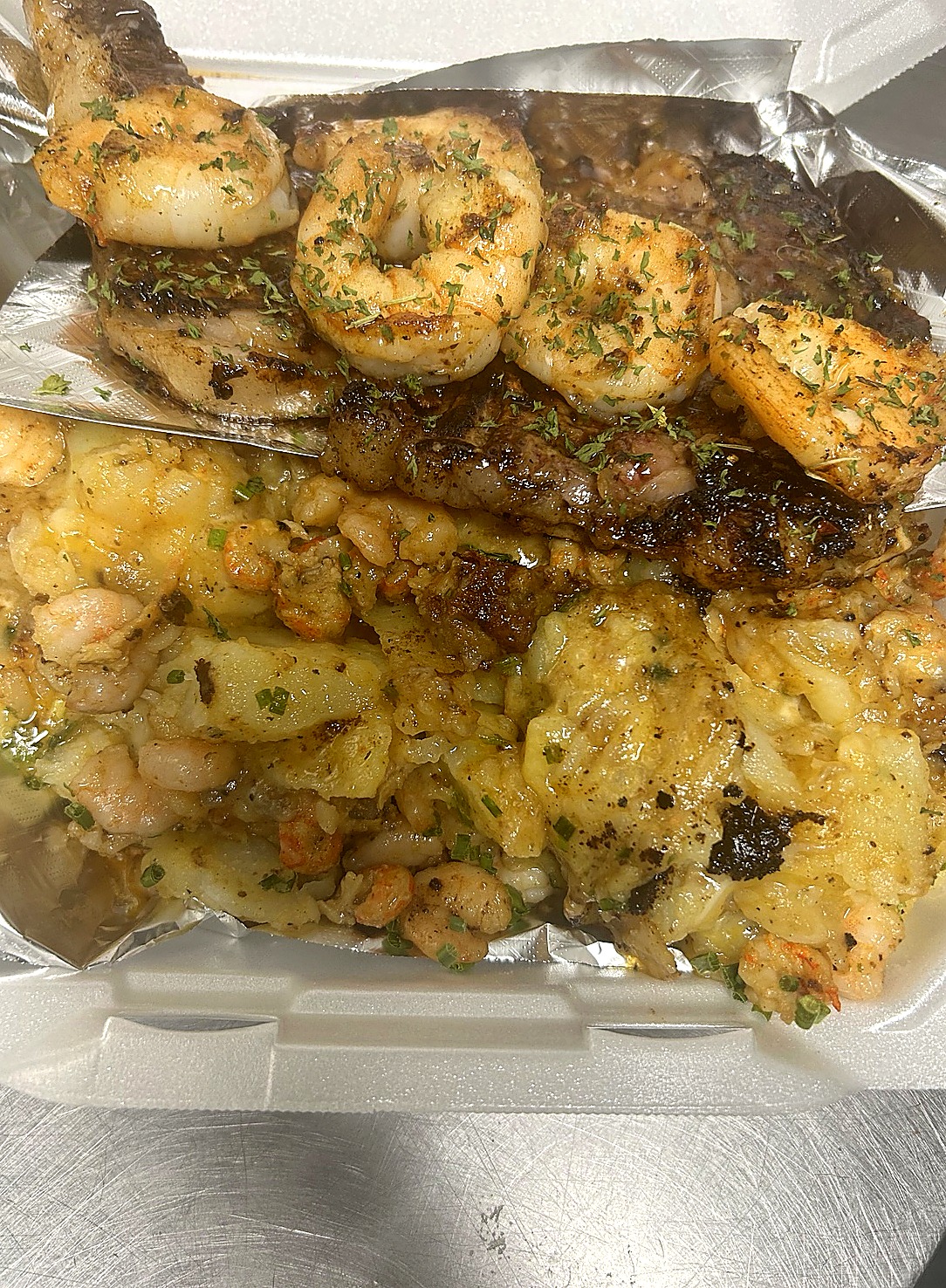 Steak plate with shrimp and loaded potatoes